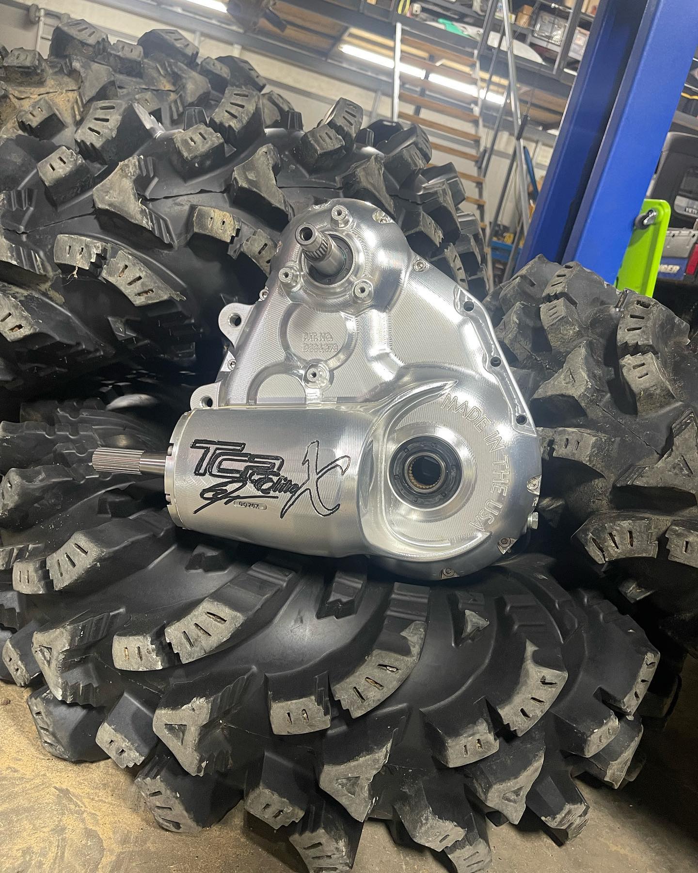Polished aluminum TC2 Racing transfer case on aggressive mud terrain tires
