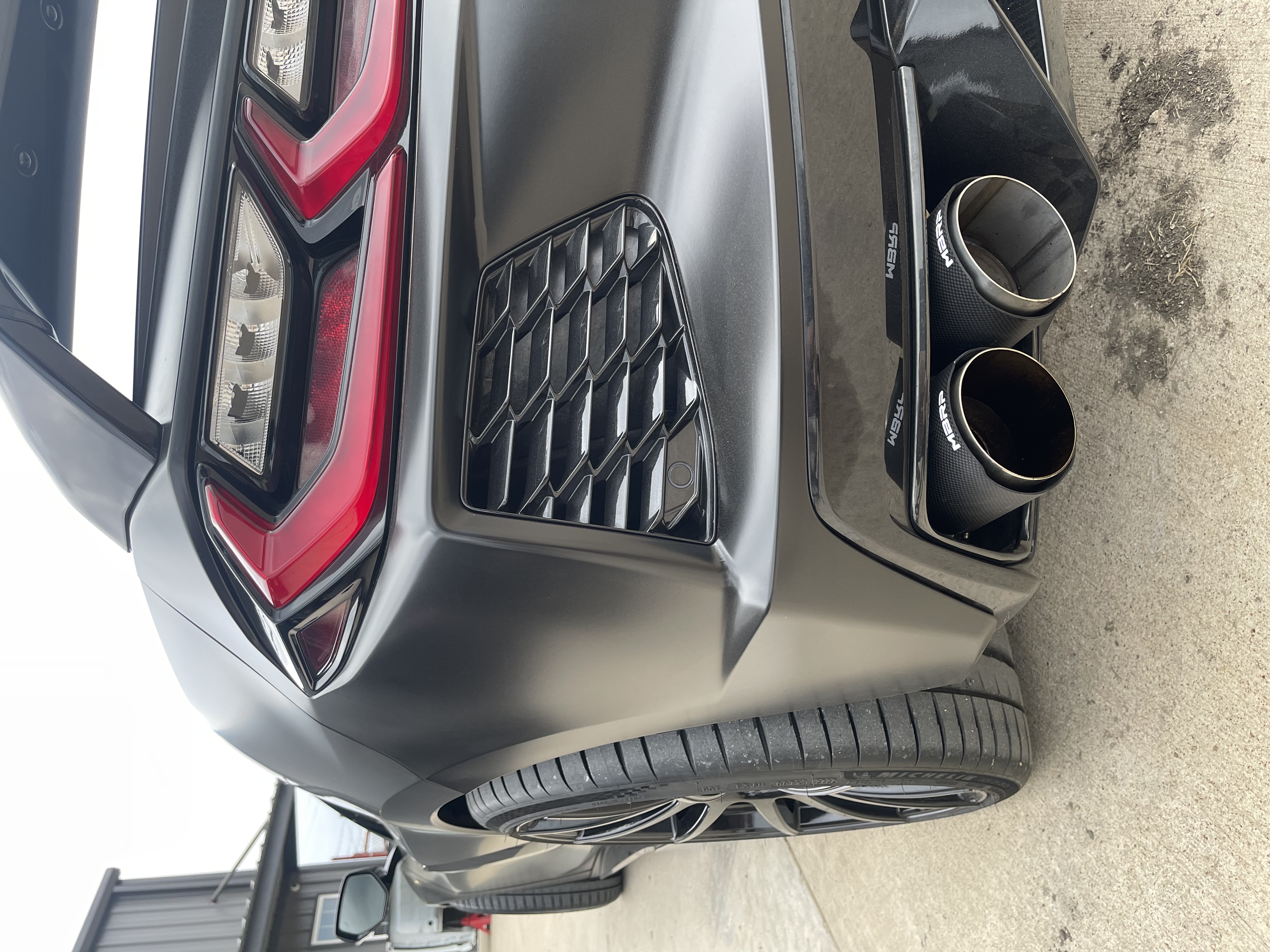 Close-up of custom MBRP dual exhaust tips on performance vehicle