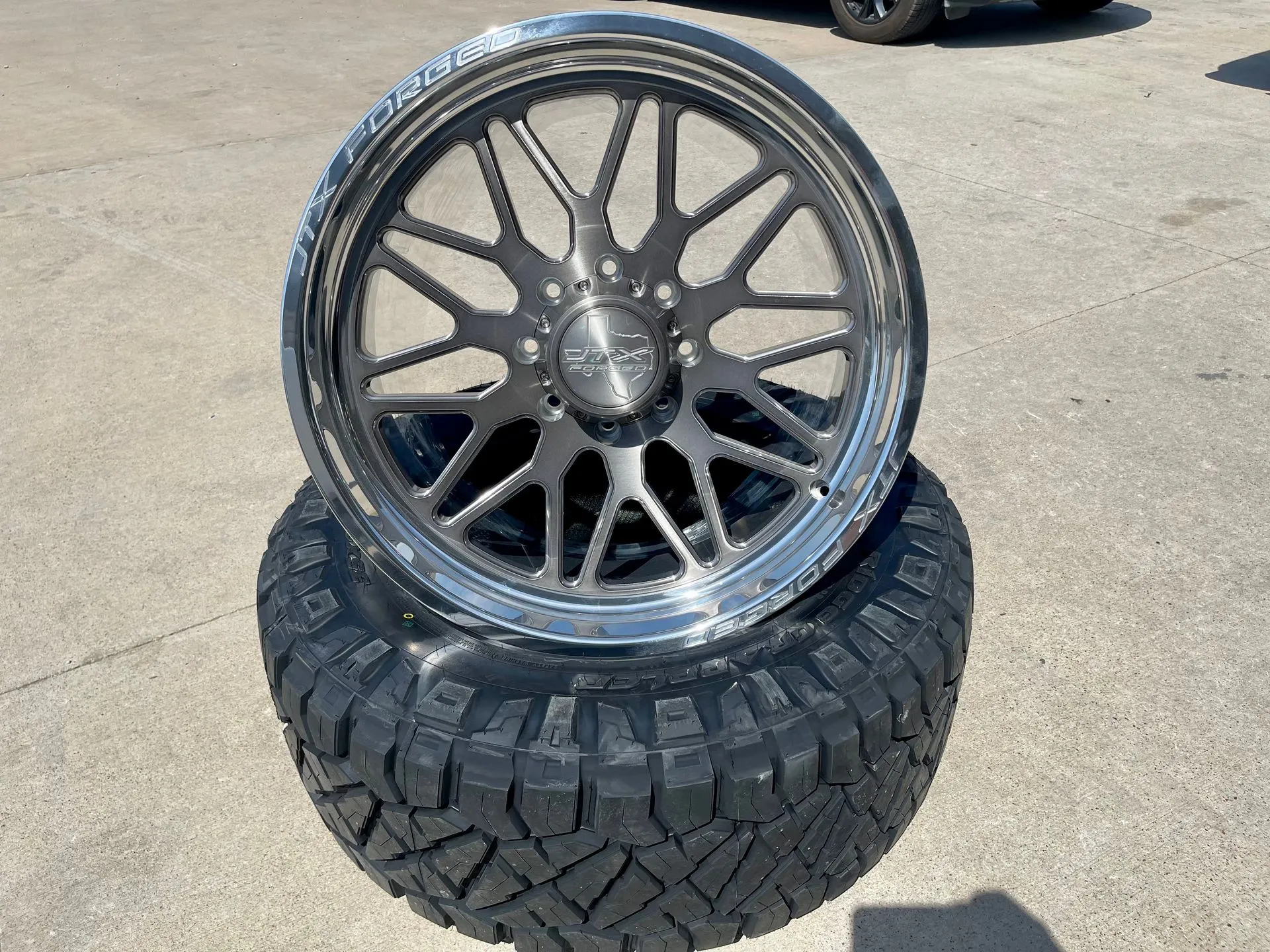 Premium aftermarket wheel with polished lip on Nitto off-road tire